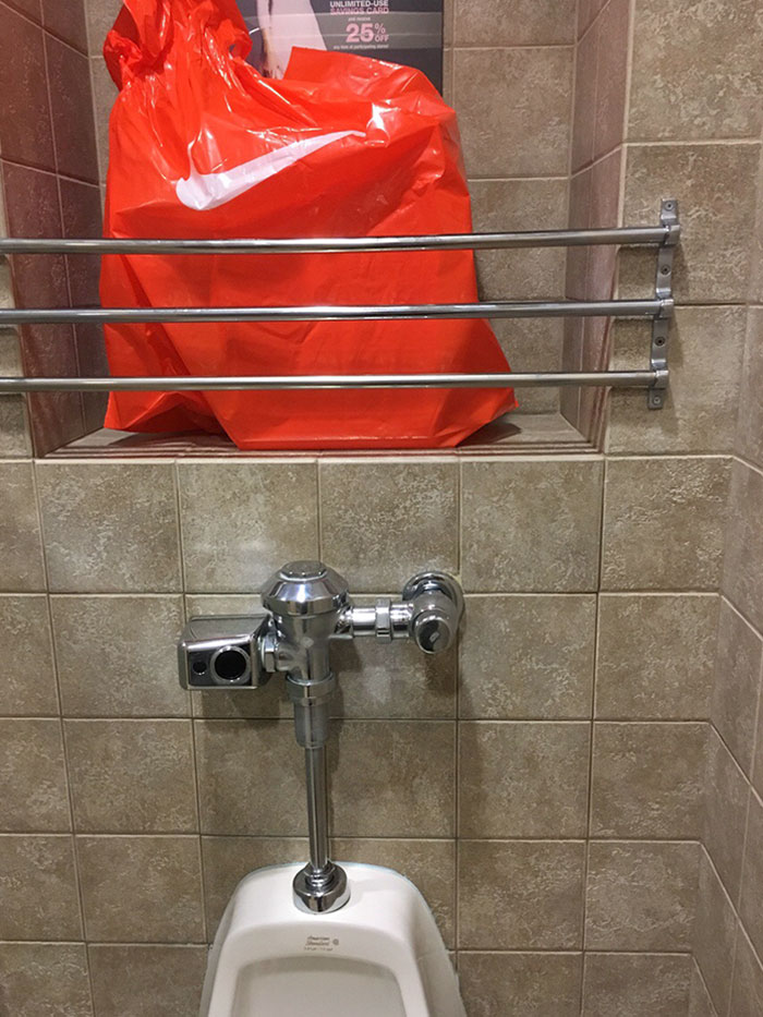 The Urinal In This Restroom Has A Ledge To Rest Your Shopping Bags