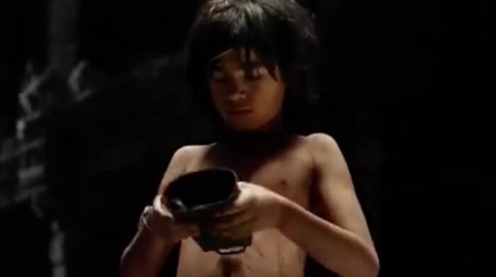 [the Jungle Book 2017] Mowgli Picks Up A Cowbell And Inspects It Before Meeting 'King Louie' Played By Christopher Walken