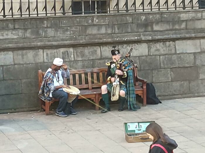A Touching Moment Between A Scottish Piper And A Traditional African Drummer As They Play Together In Edinburgh. It Was A Beautiful Display Of Humanity But Unfortunately It Sounded Like A Cat Being Kicked Down A Flight Of Wooden Stairs