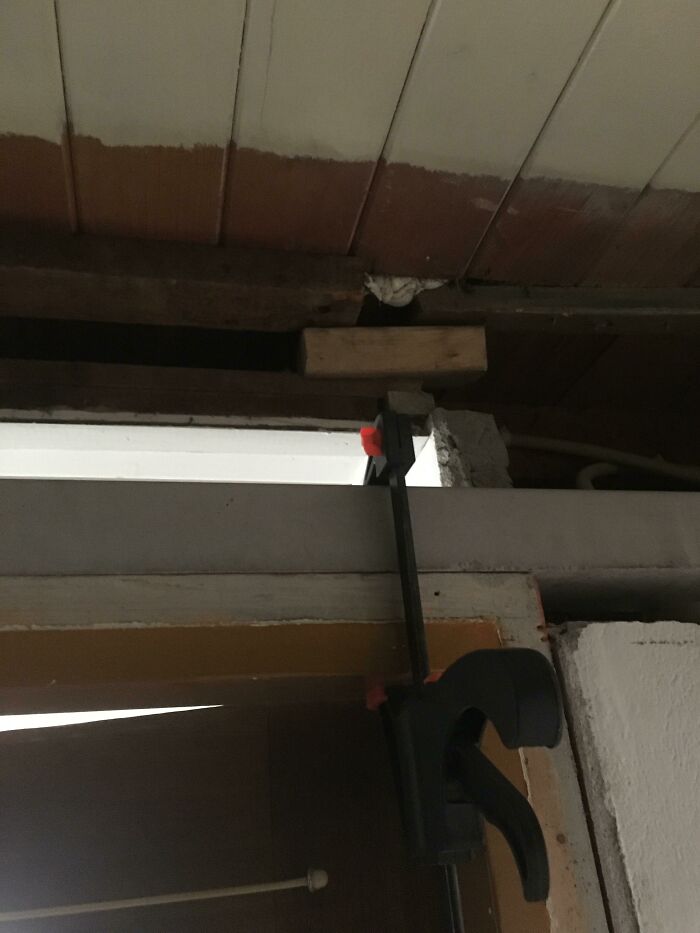 Someone Decided It Was A Good Idea To Remove The Upper Part Of A Supporting Wall In An Old Home. The Little Bright Piece Of Wood Is Holding Everything Up Now