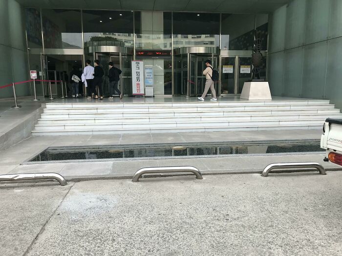 3 Inch Deep Pool That Blocks The Entire Staircase Entrance To This Building
