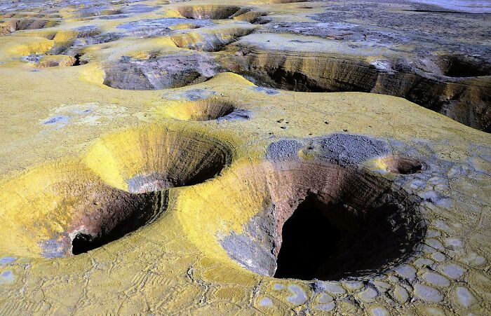 Unbelievable photos of Earth's unique landscape, with numerous yellow and gray craters. Glimpses into another universe.