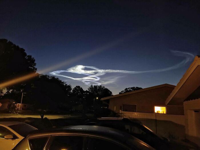 This Was Taken This Morning. It's A Very Odd Shaped Cloud, Or Maybe Even Vapor Trail. I'm Guessing It's Illuminated By The Approaching Sunrise. This Is From Clearwater Florida, Facing East. Google Lens Said Maybe A Rocket Launch?