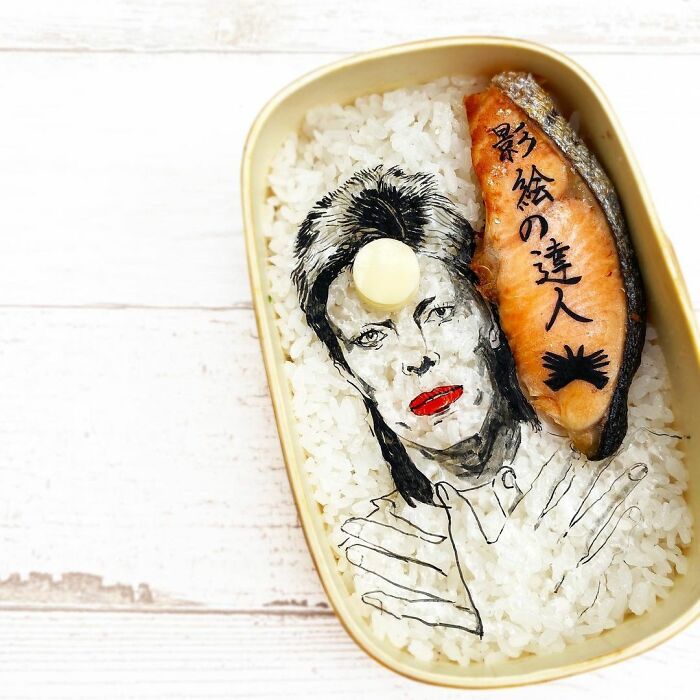 Bento artist creates detailed lunchbox with rice art portrait and salmon inspired by favorite TV shows and movies.