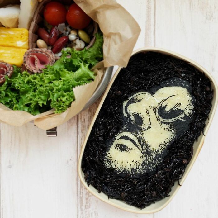 Bento artist’s detailed lunchbox featuring a black and white portrait inspired by TV shows, movies, and manga favorites.