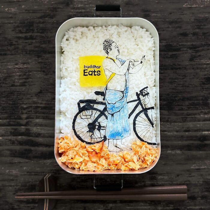 Bento artist creates detailed lunchbox featuring a Buddha figure and bicycle made with rice and edible materials.