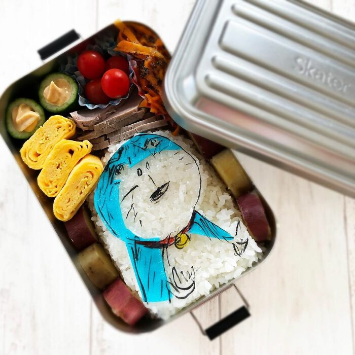 Bento artist creates detailed lunchbox with rice art of favorite manga character and colorful side dishes for her husband.