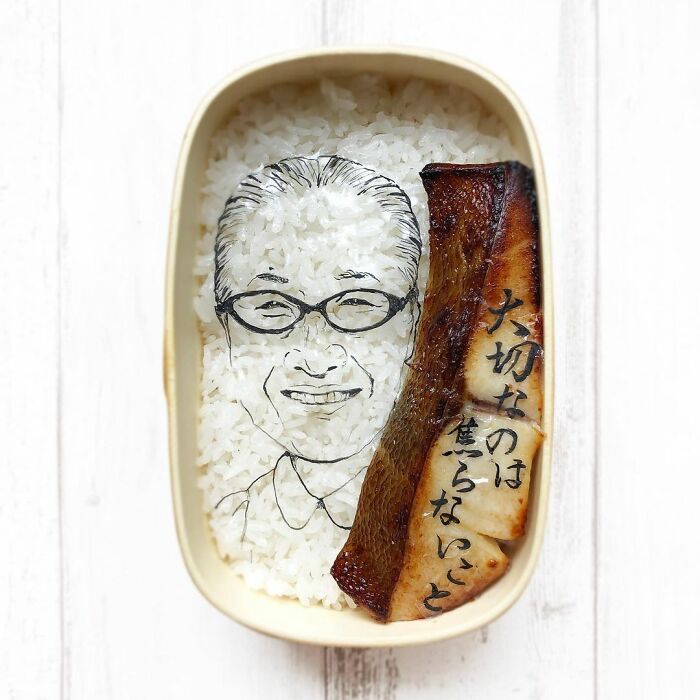 Bento artist creates detailed lunchbox portrait with rice and grilled fish reflecting favorite TV shows and manga.