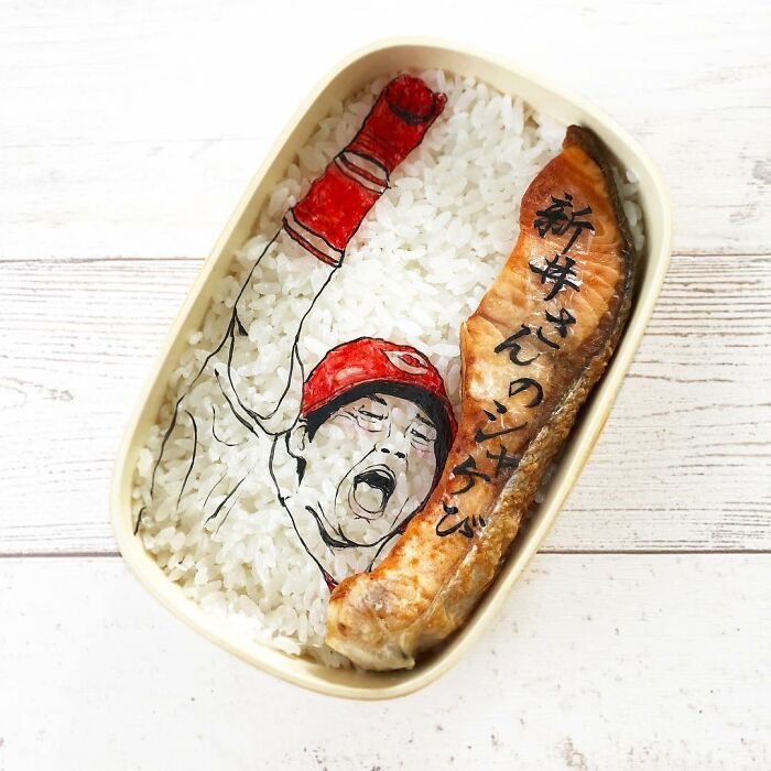Bento artist creates detailed lunchbox with rice and salmon featuring a character from favorite TV shows and manga.