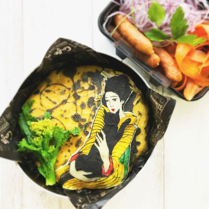 Bento artist’s detailed lunchbox featuring a woman holding a black cat, inspired by manga and favorite TV shows and movies.
