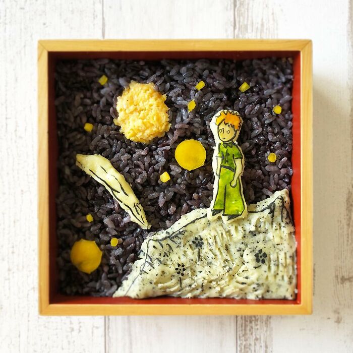 Bento artist creates detailed lunchbox with black rice and character design inspired by favorite manga and TV shows.