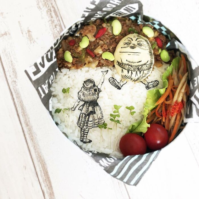 Bento artist lunchbox featuring detailed character art on rice with vegetables and seasoned ground meat.