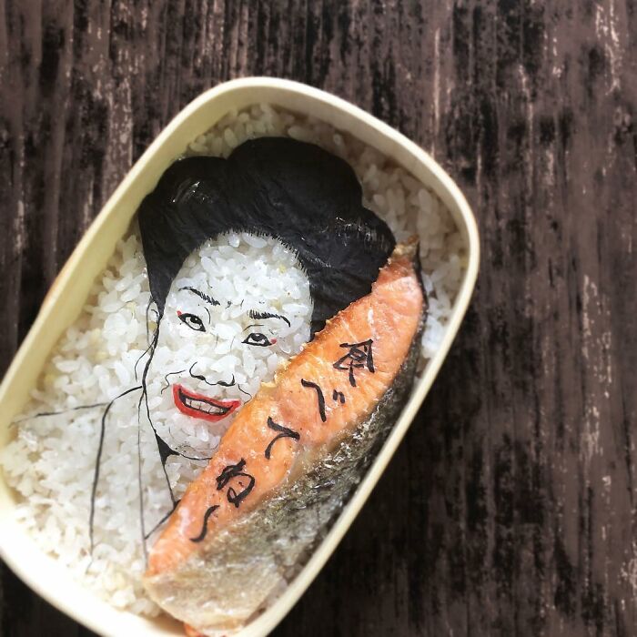 Bento artist creates detailed lunchbox featuring a rice portrait and salmon inspired by favorite TV shows and movies.