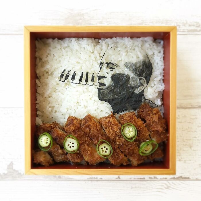 Bento artist creates detailed lunchbox with rice and fried food featuring a portrait inspired by TV shows and manga.
