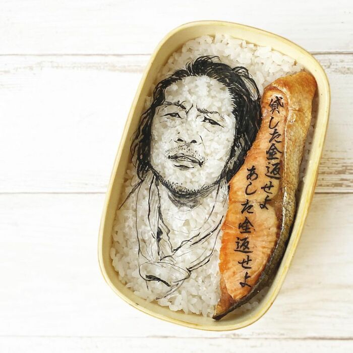Bento artist creates detailed lunchbox with rice portrait and salmon inspired by favorite TV shows and movies.