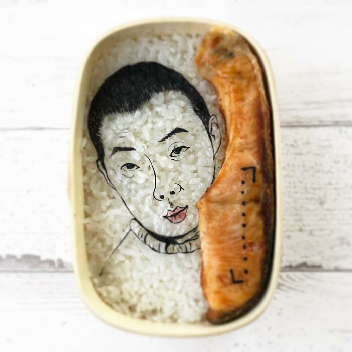 Bento artist creates creative lunchbox with rice art and fish inspired by favorite TV shows and movies.