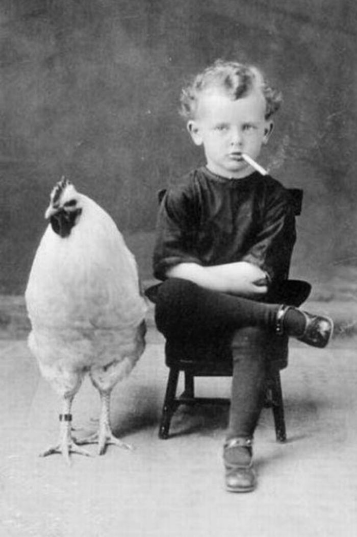 A Kid With A Cigatette & A Chicken