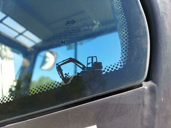 There's A Cute Little Excavator Graphic On The Window Of This Excavator