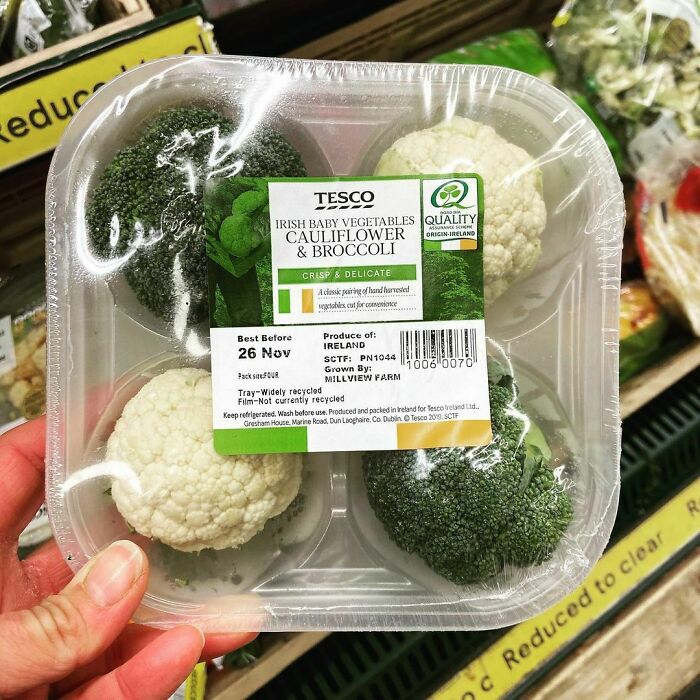 Cauliflower And Broccoli Nested On A Single Use Plastic Tray Wrapped In Pointless Plastic Wrap