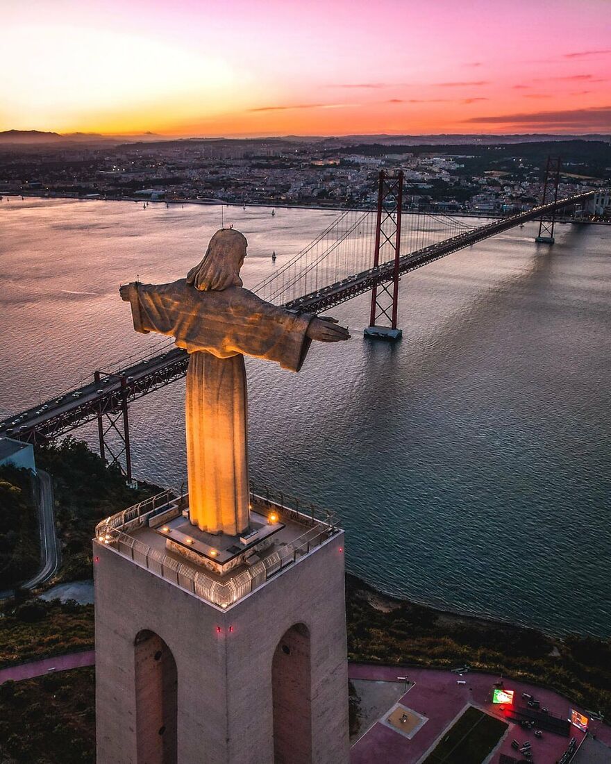 Sanctuary Of Christ The King With View Of The Ponte 25 De Abril In Lisbon, Portugal