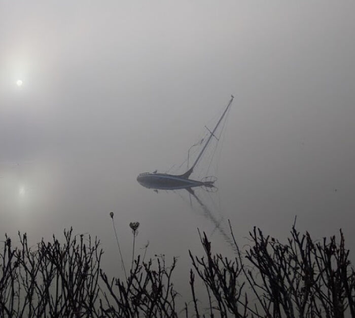 Sunken Sailboat On A Foggy Day