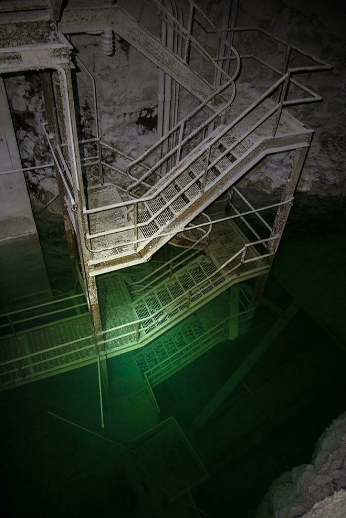 Stairs Down To Flooded Machinery Deep Inside A Mine