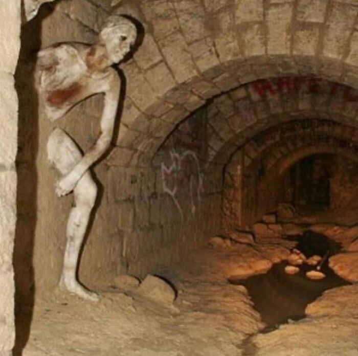 The Passer-Through-Walls (Le Passe-Muraille) Sculpture In The Paris Catacombs