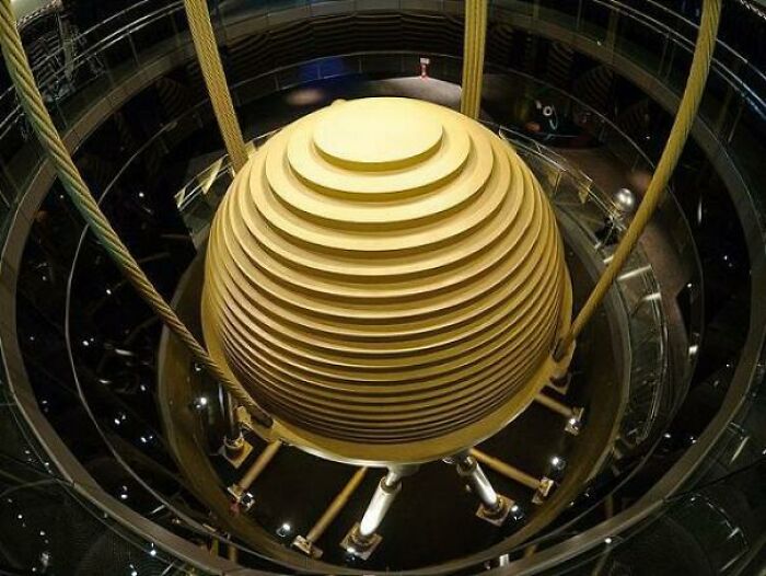 The Tuned Mass Damper Of Taipei 101 Skyscraper. A Tuned Mass Damper Is A Device Mounted In Structures To Reduce The Amplitude Of Mechanical Vibrations. Their Application Can Prevent Discomfort, Damage, Or Outright Structural Failure