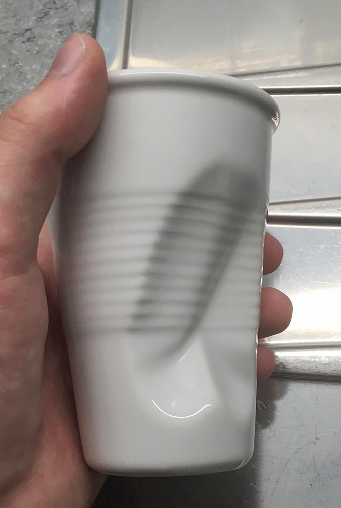 A Mug In The Design Of A Dented Plastic Cup