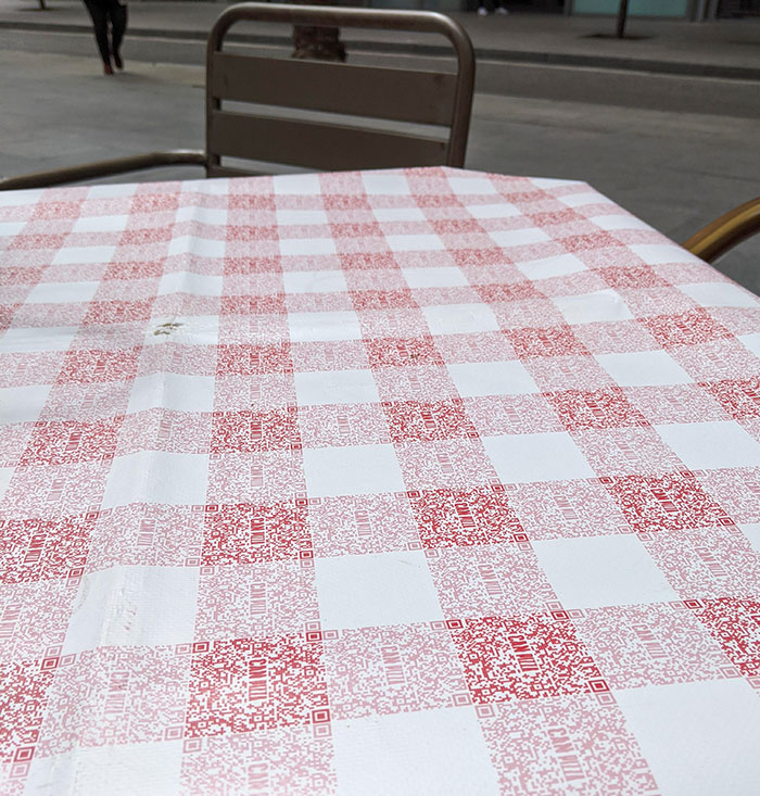 The Classic Red Checkered Pattern Of The Tablecloth Of This Restaurant Is Made Of QR Codes For Their Menu