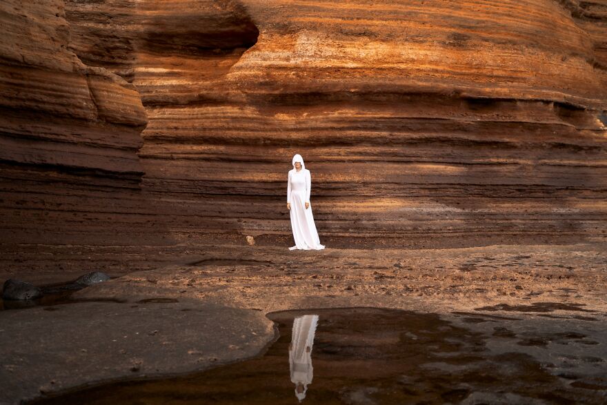 The Ocean Here Was At Reflux, So She Could Climb The Layers Of Rocks And Explore The Cliffy Planet. In Her White Suit She Could Hide, Yet Be Visible At The Same Time. After All, She Had Traveled For So Long That She’d Forgotten The Notion Of Home