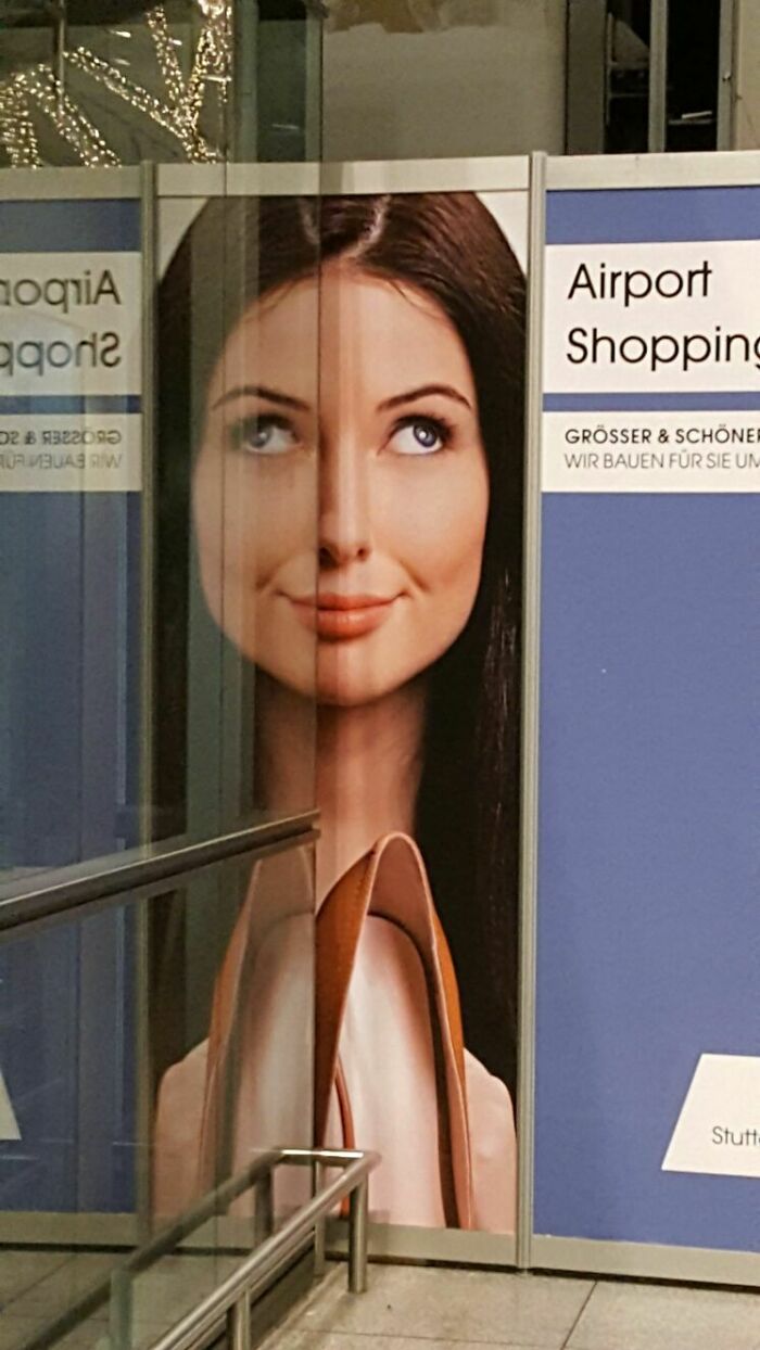 Reflection Of A Poster In The Stuttgart Airport Makes The Woman Look Cross-Eyed