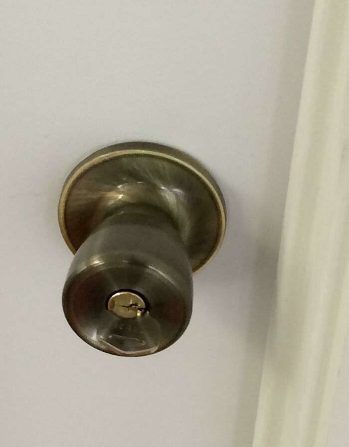 The Color And Reflective Properties Of The Key Make It Blend In With The Doorknob