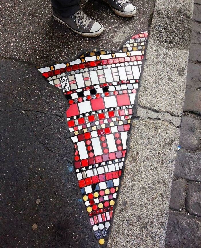 An Artist In Lyon Known As “The Pavement Surgeon” Repairs The City’s Sidewalks Using Colorful Mosaics That He Describes As “A Poem That Everybody Can Read”