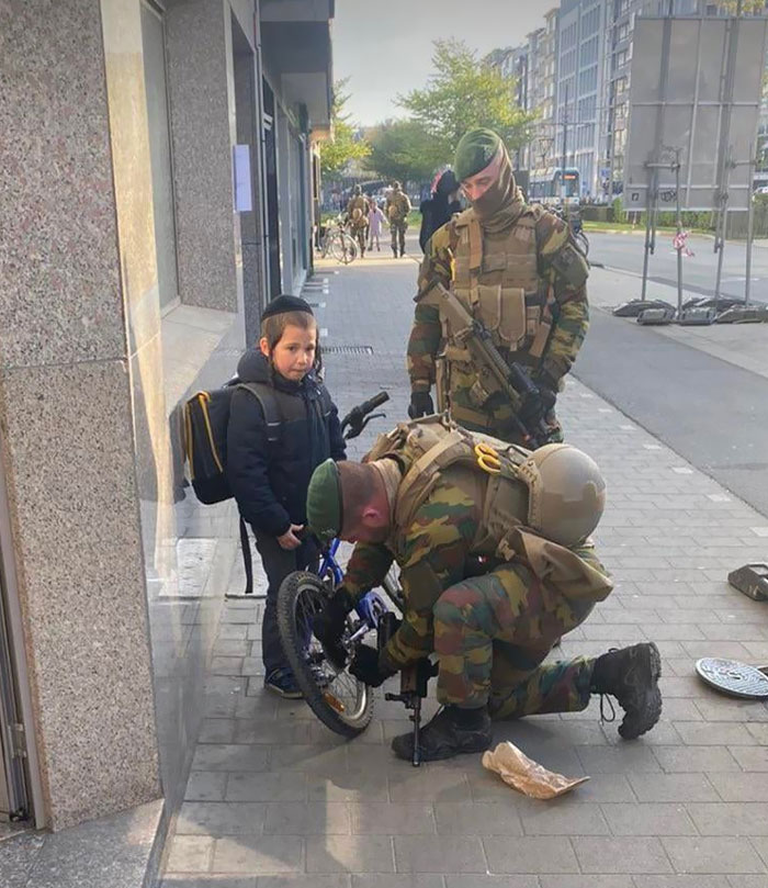 Belgian Paratroopers Assigned To Guard The Jewish Neighborhood In Brussels Helping A Jewish Boy With His Bike