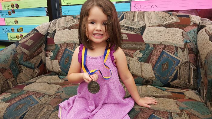 My Daughter Earning Her Medal For 1,000 Books Before Kindergarten. So Proud Of Her. Sadly, And Awesomely, She's Been Through More Books In Her Life Than I Have