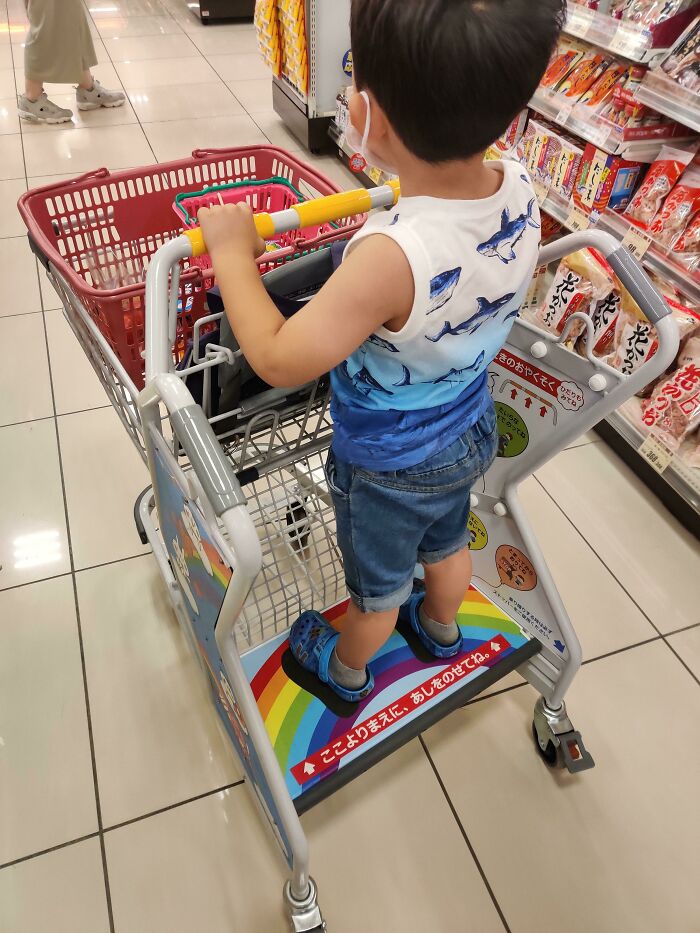 This Shopping Cart Has A Spot For Kids To Stand On While The Parent Pushes