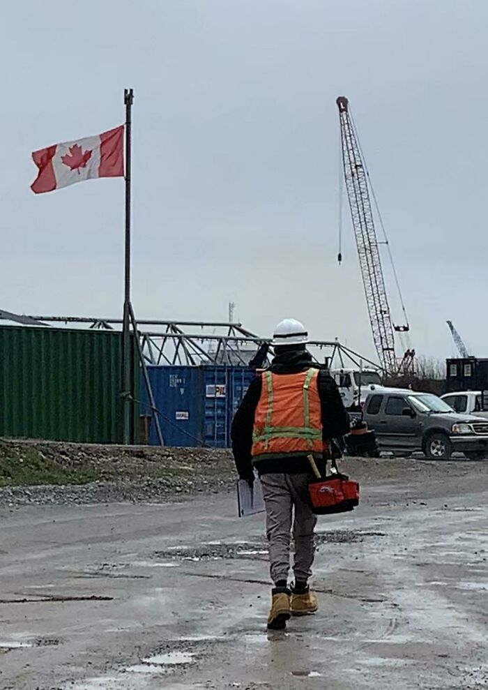 Me With An Inside-Out Vest Covered In Painter’s Tape, My Mom’s Toolbag, A Clipboard With Miscellaneous Marine Documents And Some Charts, And A Hardhat On - Nearly Making It Into A Marine Scrapyard Completely Unnoticed