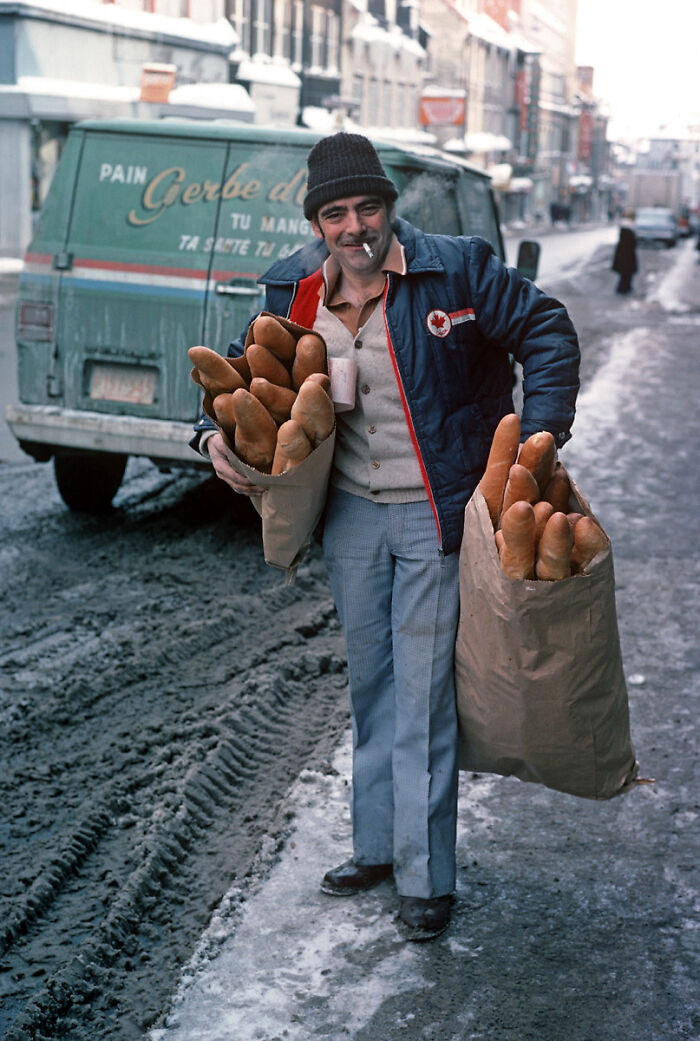 A Bread Delivery Man With Bags Filled With Baguettes On A Snowy Street In Quebec In 1977