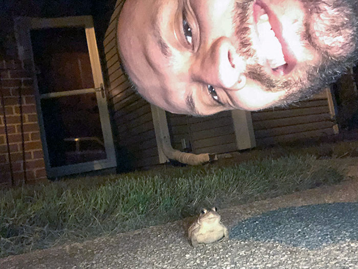 For The Past Month, This Frog Jumps From Out Of The Grass Onto The Sidewalk Each Night When We Get Home. This Is My Boyfriend Taking A Selfie With Him. His Name Is Jamal