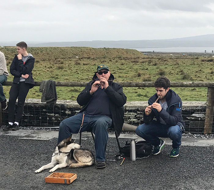 The Older Man Was Playing His Flute For Money By The Cliffs Of Moher In Ireland. The Younger Guy Walked Up, Pulled A Flute Out Of His Coat (Who Carries A Flute?) And Joined Him