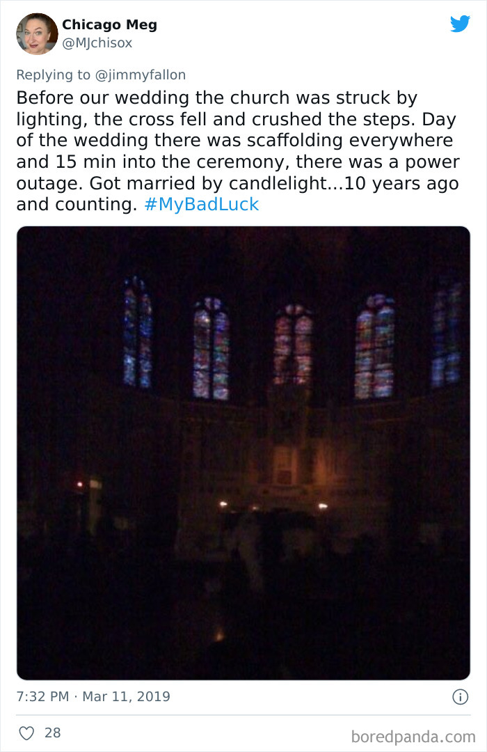 Dark church interior with stained glass windows barely visible during a power outage, illustrating a bad luck moment shared on Twitter.