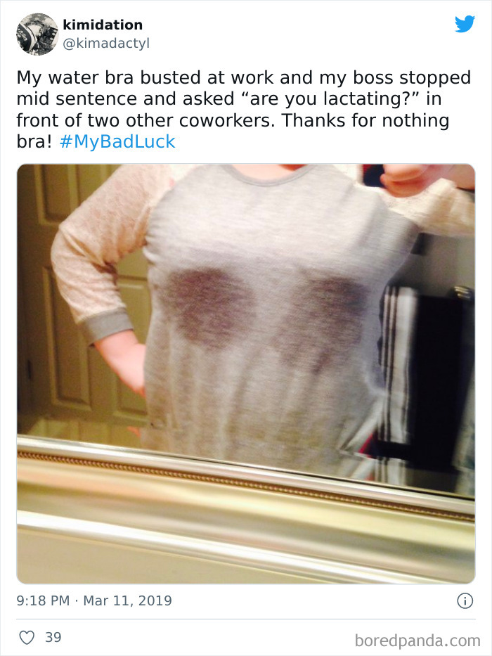 Woman taking a mirror selfie showing wet shirt from busted water bra in a funny bad luck moment shared on social media.