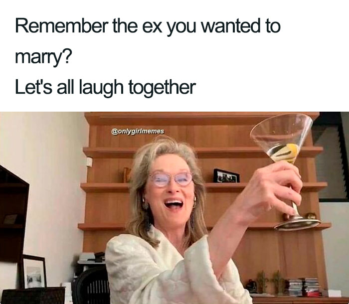 Woman in glasses joyfully raising a cocktail, captioned with a humorous meme about exes.