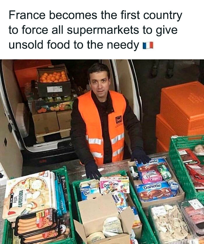 Man in orange vest sorting unsold food in crates, highlighting anti-consumption efforts to reduce waste and support needy.