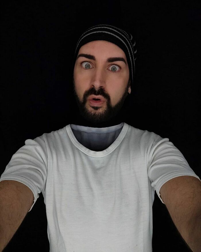 Italian artist creating optical illusions by using his body as a canvas with detailed face and shirt painting.