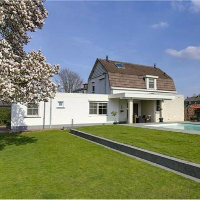 So What Came First, The Bottom Modern Villa Or The Traditional House On Top?