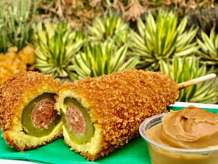 Disneyland Is Advertising A Hot Dog Stuffed Inside A Dill Pickle That Is Fried And Served With A Side Of Peanut Butter