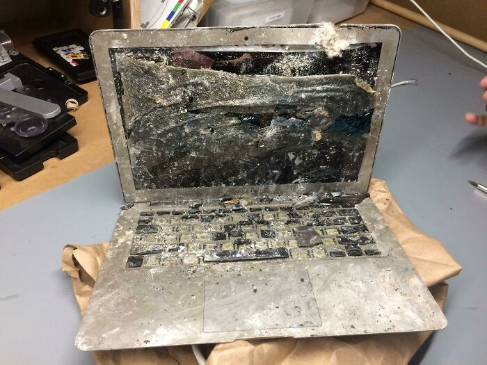 Laptop covered in dirt and debris showing one of the worst tech support cases experienced on the job.