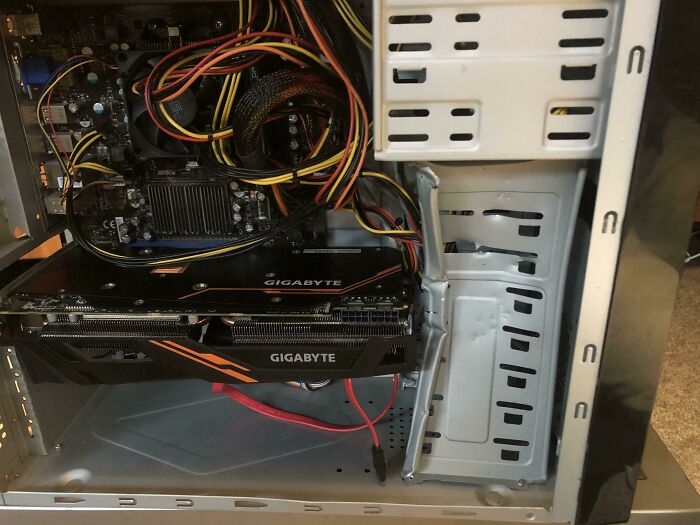 Open computer case showing tangled wires and Gigabyte graphics cards, a common tech support worst case scenario.